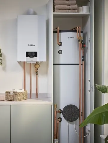 Vaillant combi boiler and unvented hot water cylinder installed in a utility cupboard by AC Plumbers Ltd. in Brighton