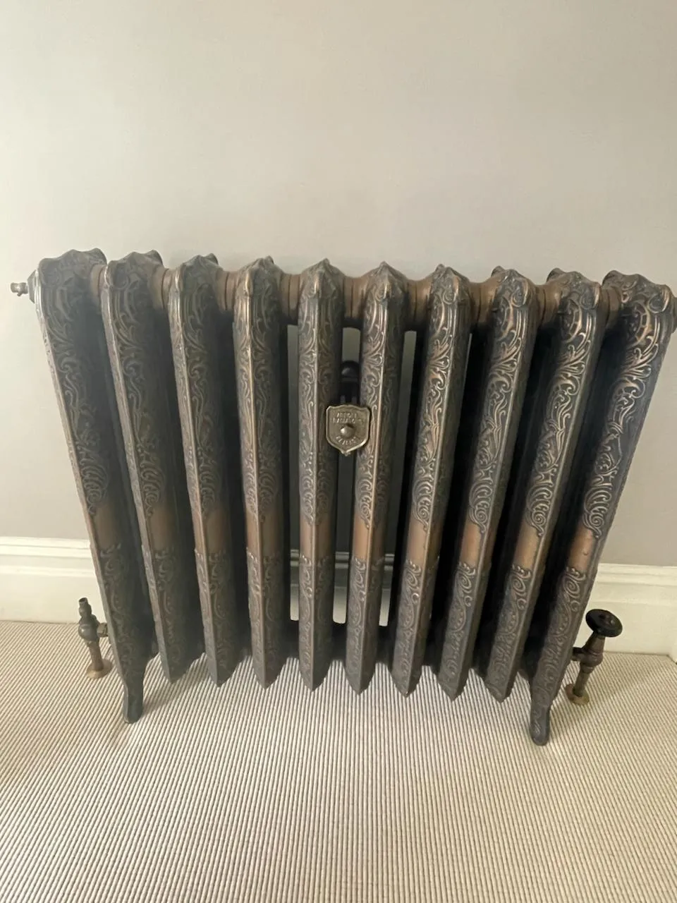 Freestanding ornate cast iron radiator with antique-style detailing