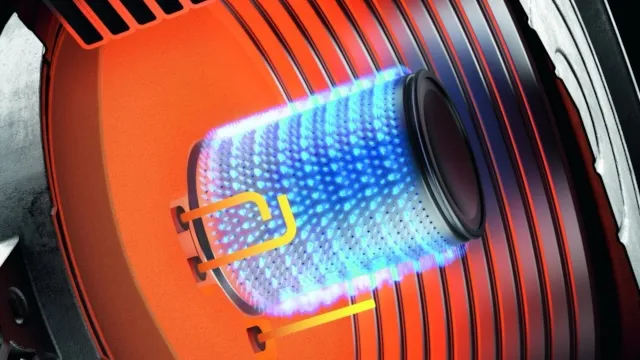 Close-up view of a Viessmann gas boiler burner with blue flame inside the combustion chamber, showing advanced heating technology.